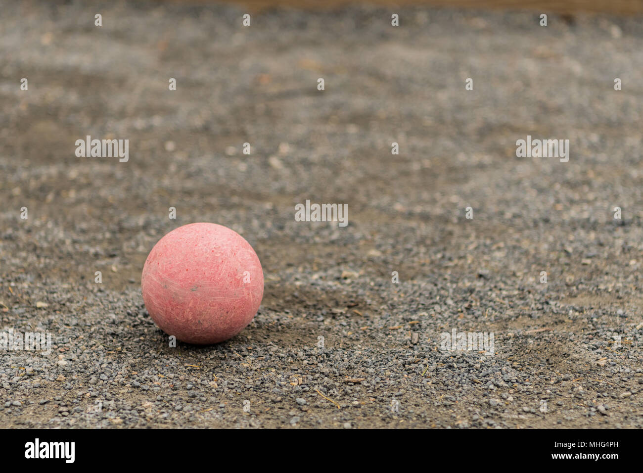 Single Red Bocce Ball Lower Left on gravel surface Stock Photo Alamy