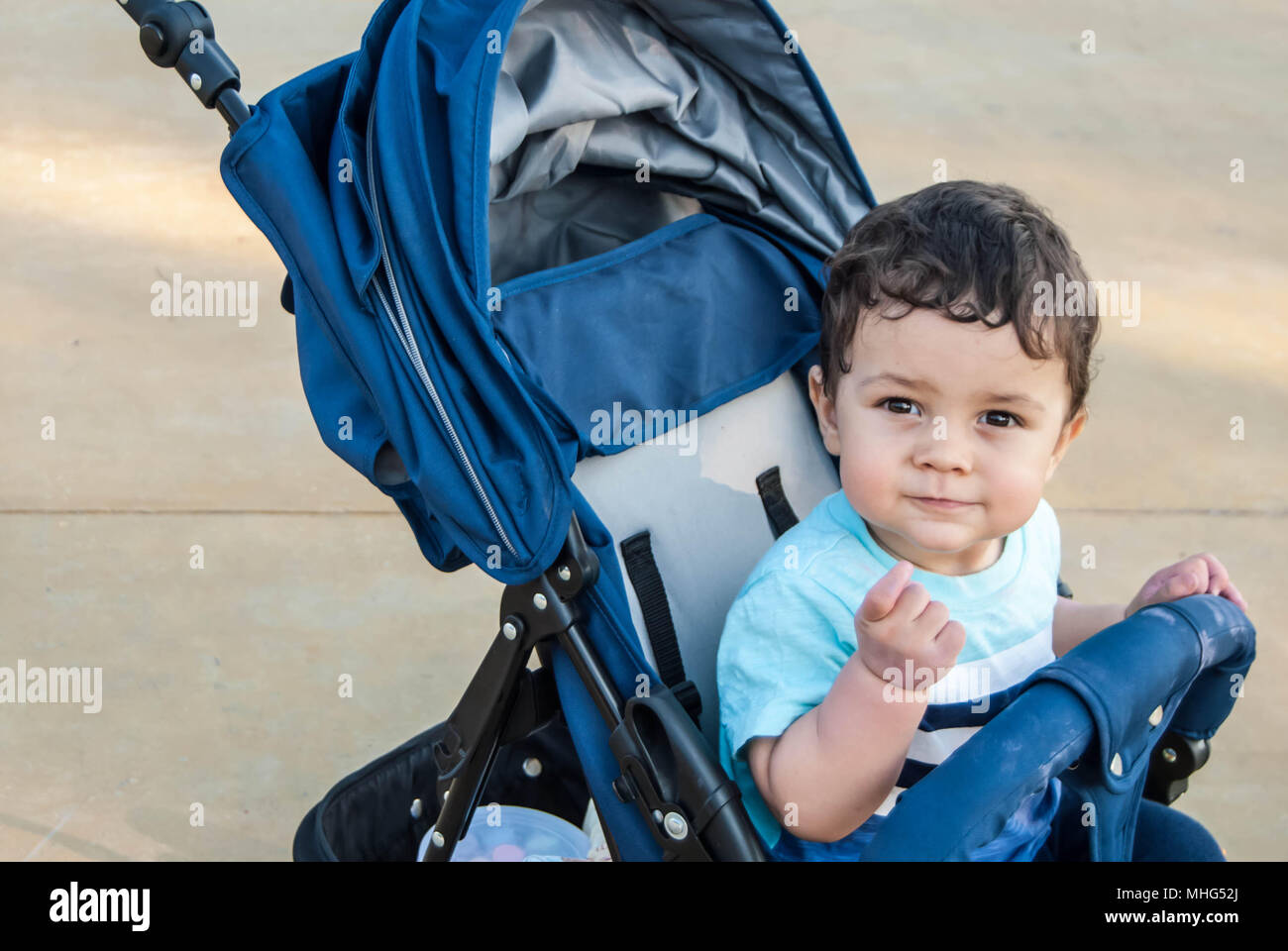 Child in a stroller in an amusement park Stock Photo Alamy