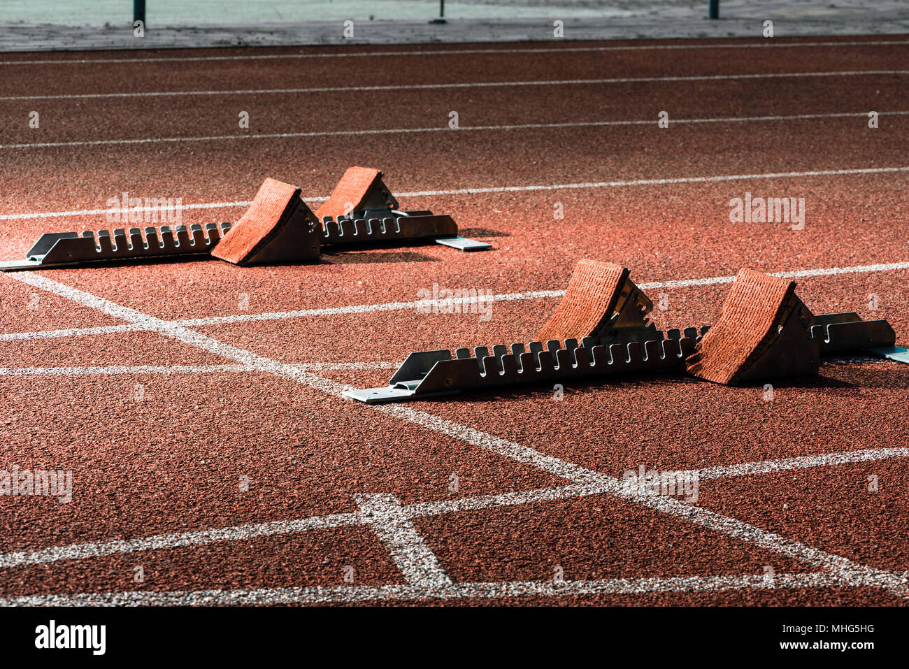 Starrting blocks at cindertrack of athletics stadium Stock Photo