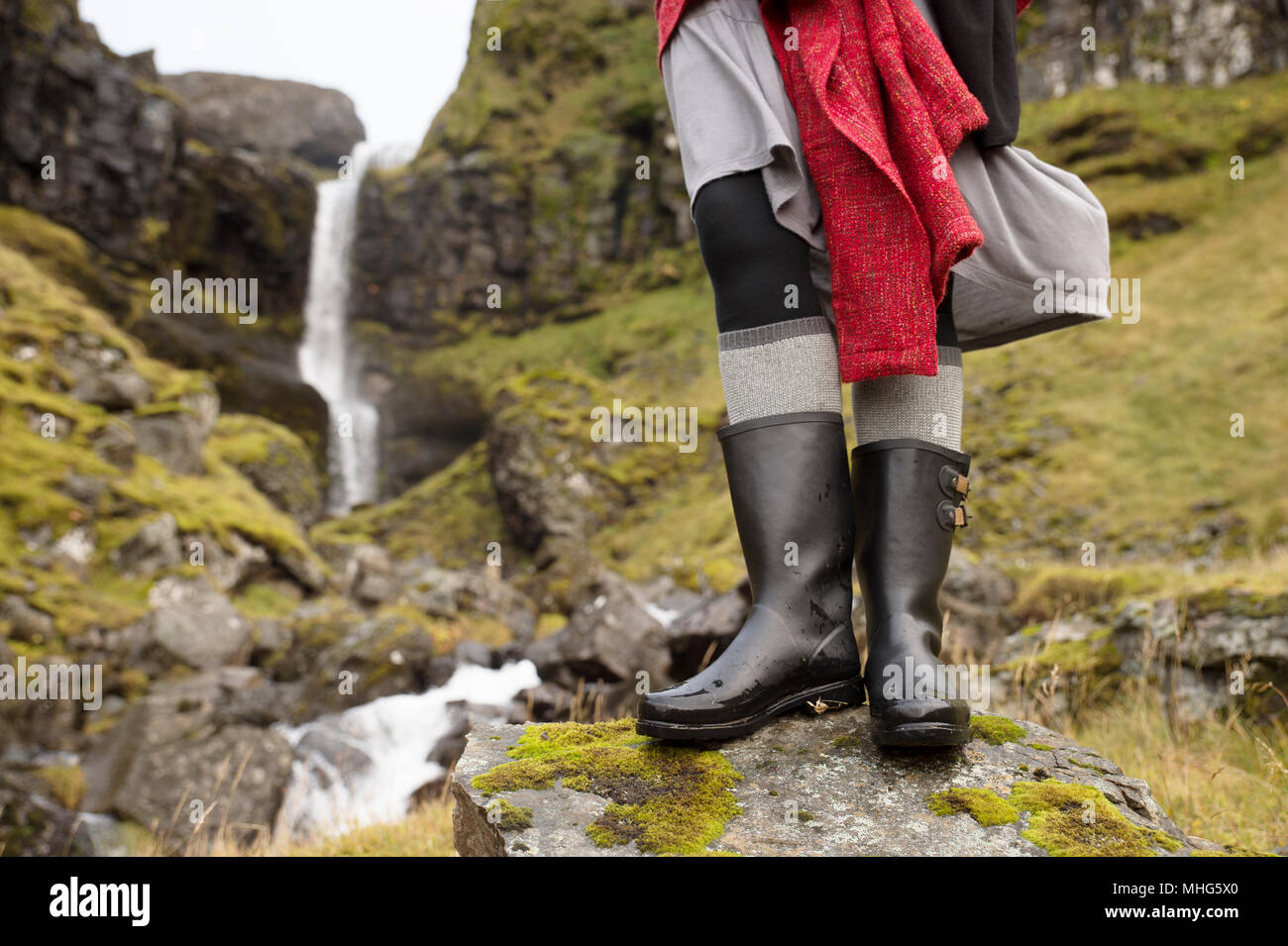 Closeup of woman in black rain boots in front of Icelandic waterfall Stock  Photo - Alamy