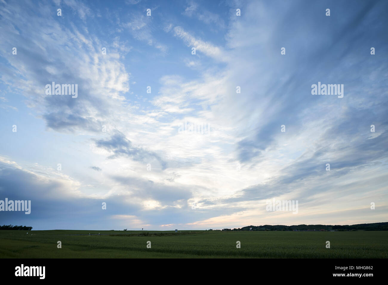 Clouded blue sky and landscape with trees and fields Stock Photo - Alamy
