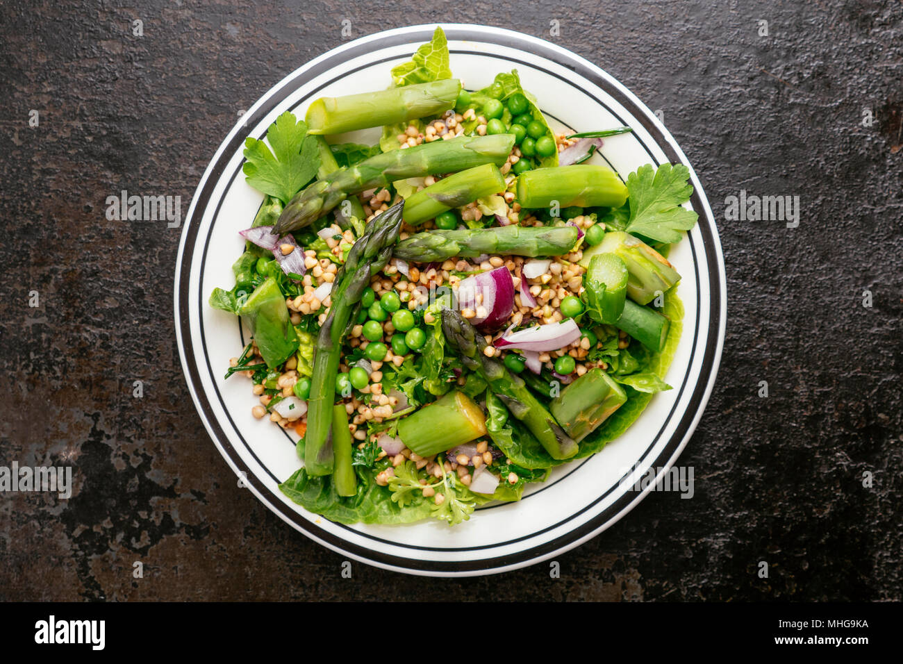 Spring Salad with Asparagus and Peas, served with buckwheat. Stock Photo