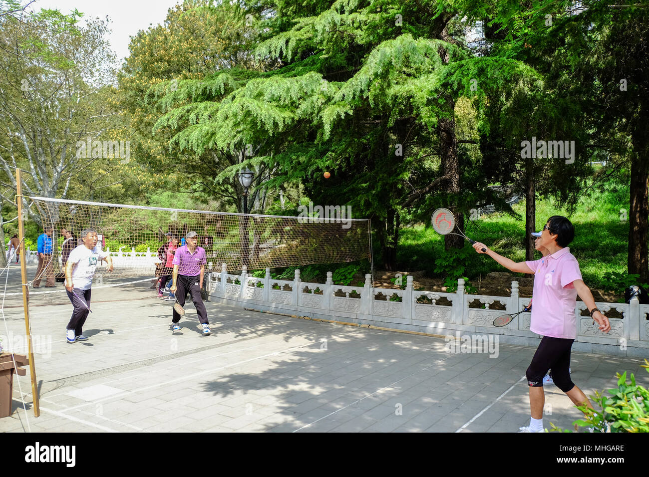 BEIJING, CHINA - APRIL 30, 2018: People are playing racket and ball in a park. Taoranting Park is a major city park located in Xicheng District in the Stock Photo