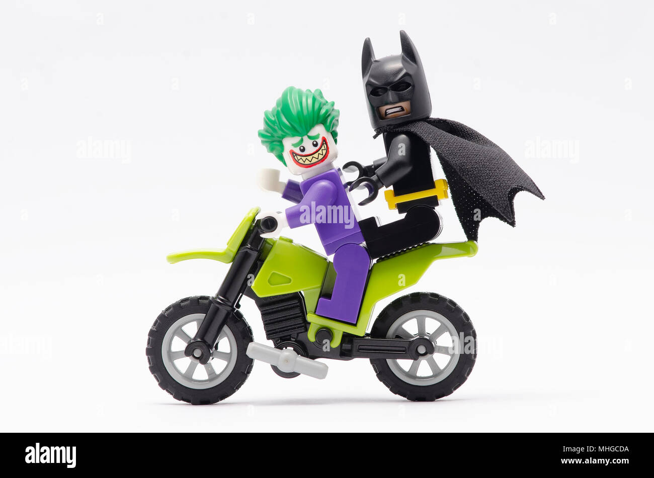 mini figure of joker with batman on her back riding dirt bike. Lego  minifigures are manufactured by The Lego Group Stock Photo - Alamy