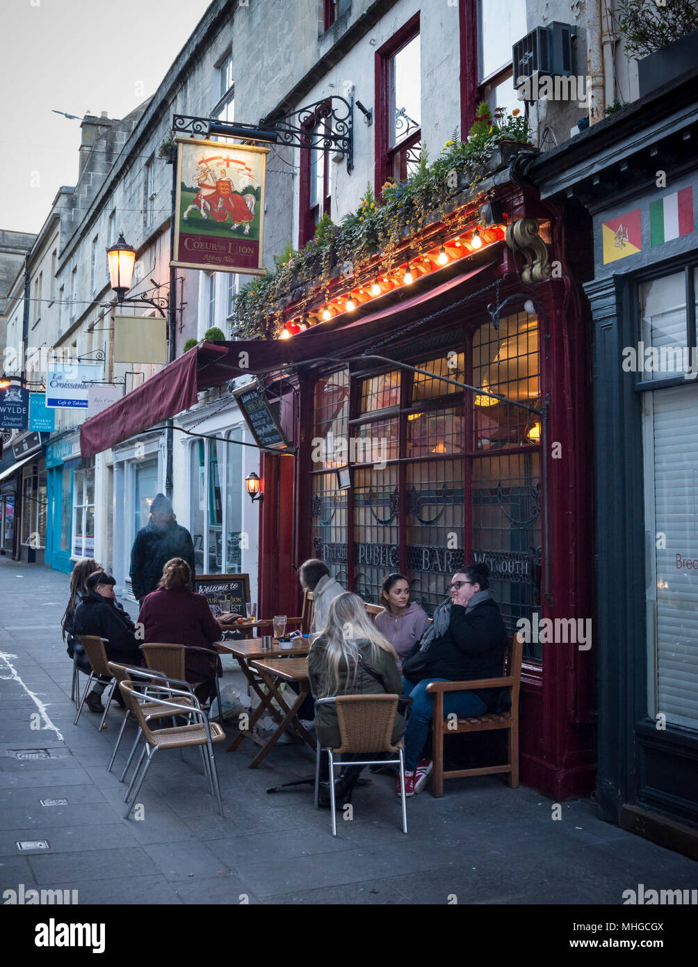 People enjoying early evening drinks sitting outside of Coeur de Lion Pub bar restauant, Bath, Somerset, UK Stock Photo