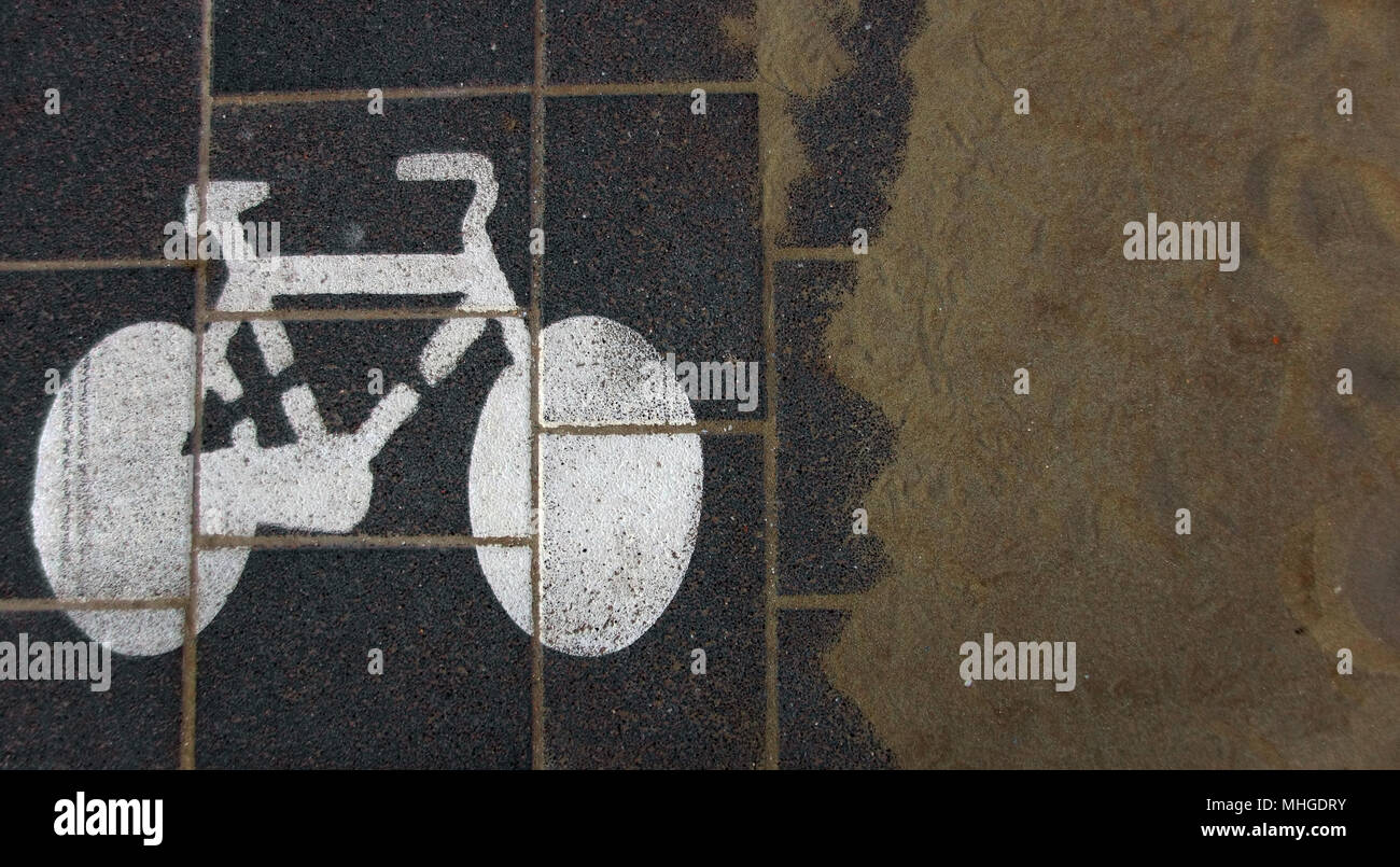 Bike lane sign soon to be covered by sand blown by the wind from a nearby beach. Stock Photo