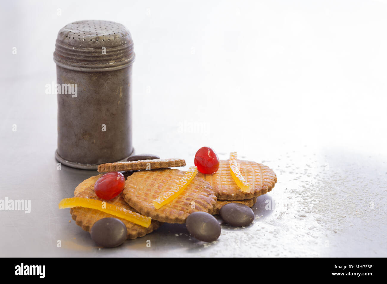 old metal sugar bowl with biscuits, chocolate and candied fruit red ...