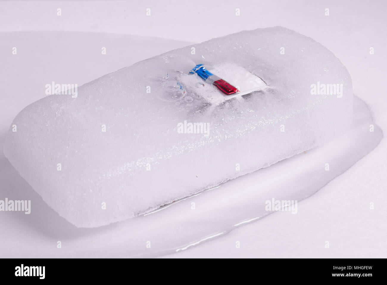 toy police car thawing from ice. frozen police car Stock Photo