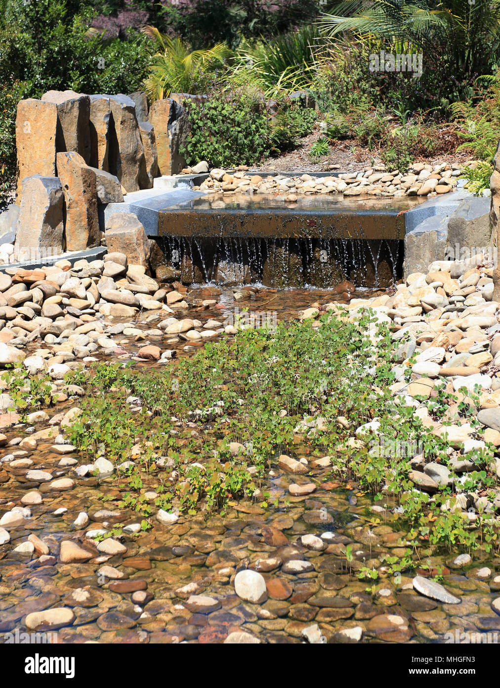 Man made water stream, water feature, waterfalls at Australia Garden in Cranbourne Australia Stock Photo