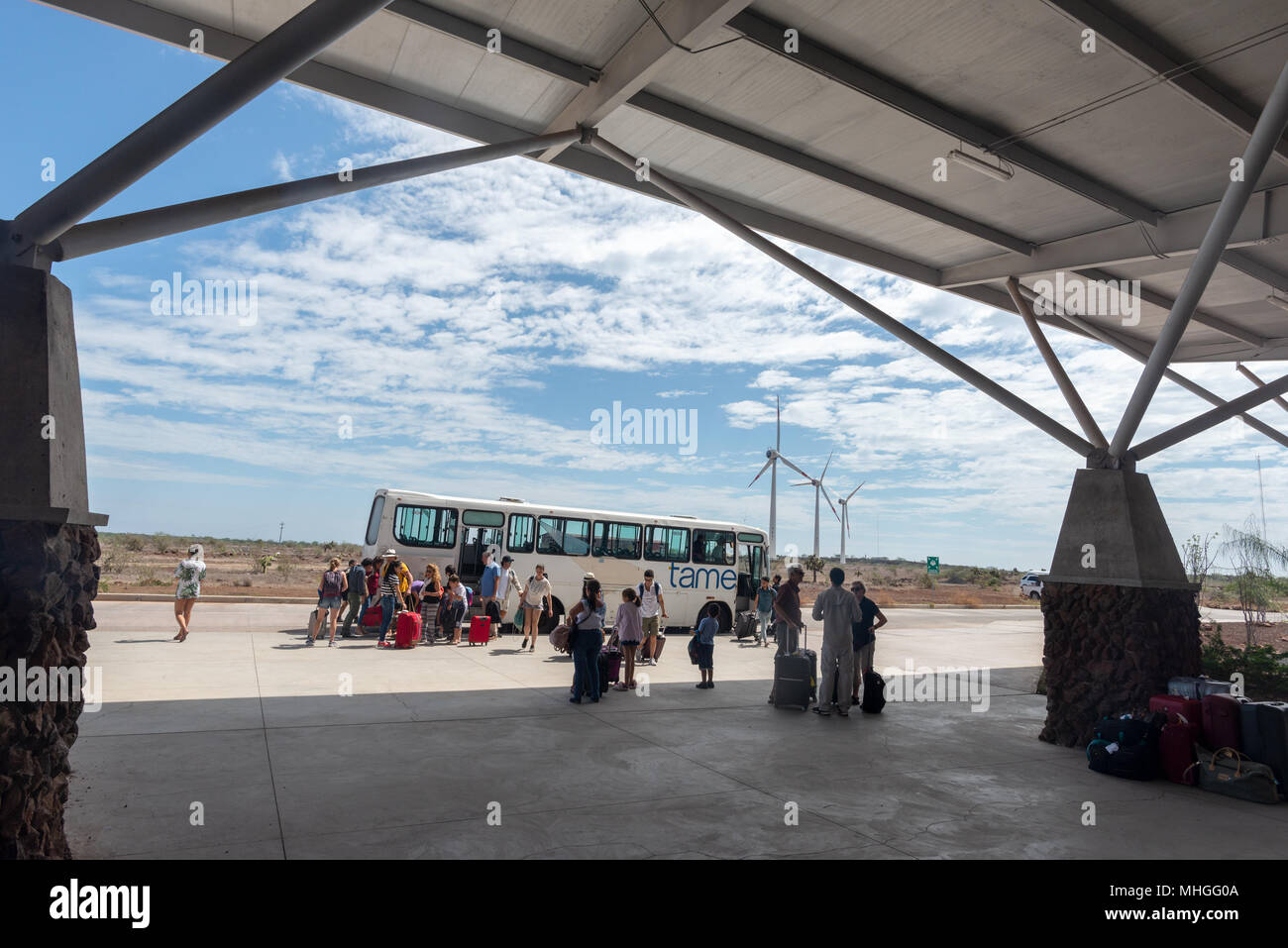 Travelers arriving by bus at the Seymour Airport terminal on Baltra Island, Galapagos Islands, Ecuador. Stock Photo