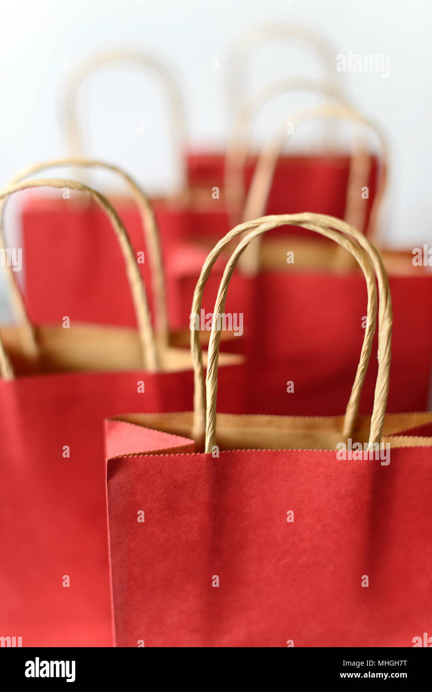 Red shopping bags from recycle paper isolated on white background. Black friday or Christmas sales. Stock Photo