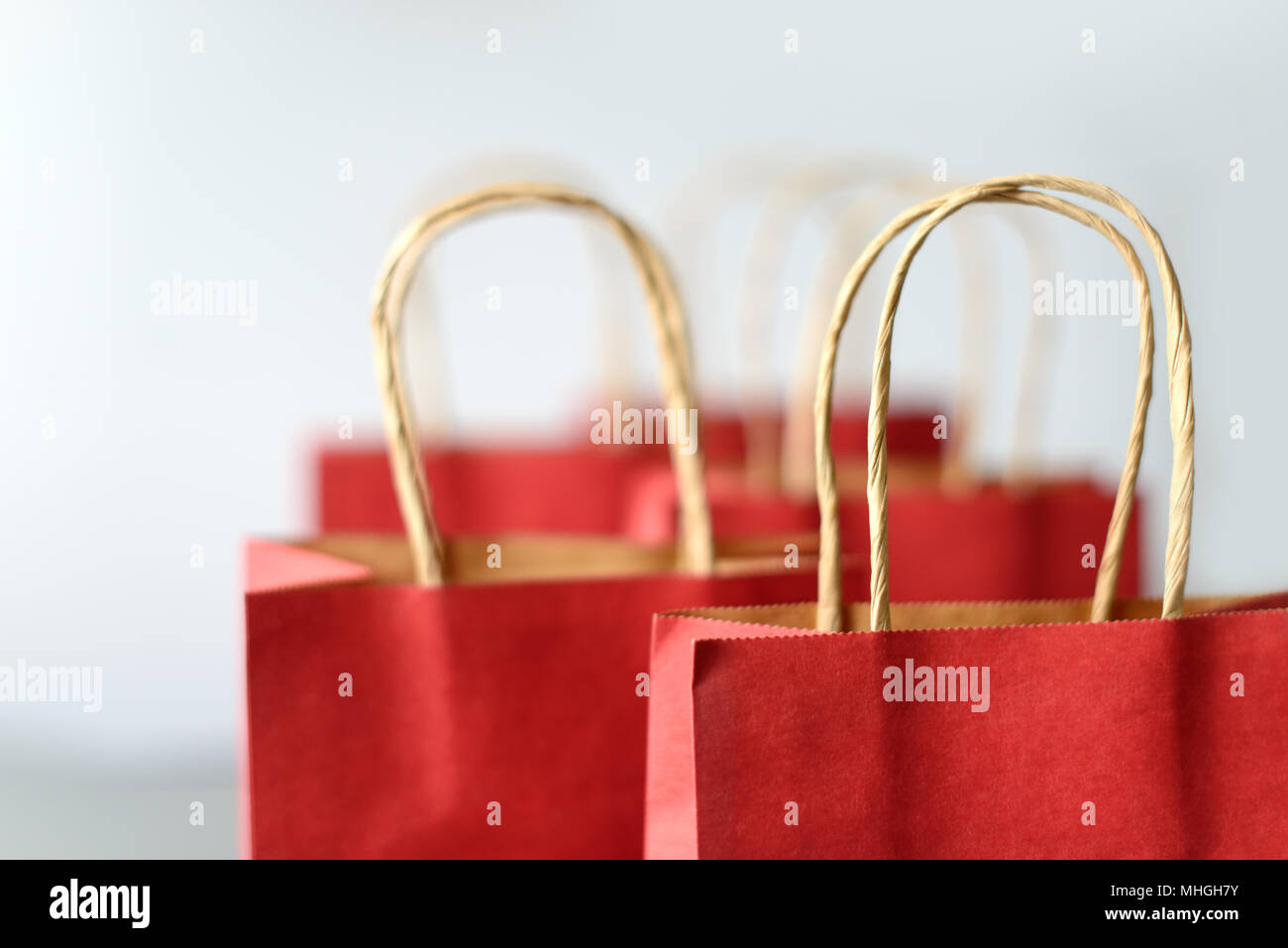 Red shopping bags from recycle paper isolated on white background. Black friday or Christmas sales. Stock Photo