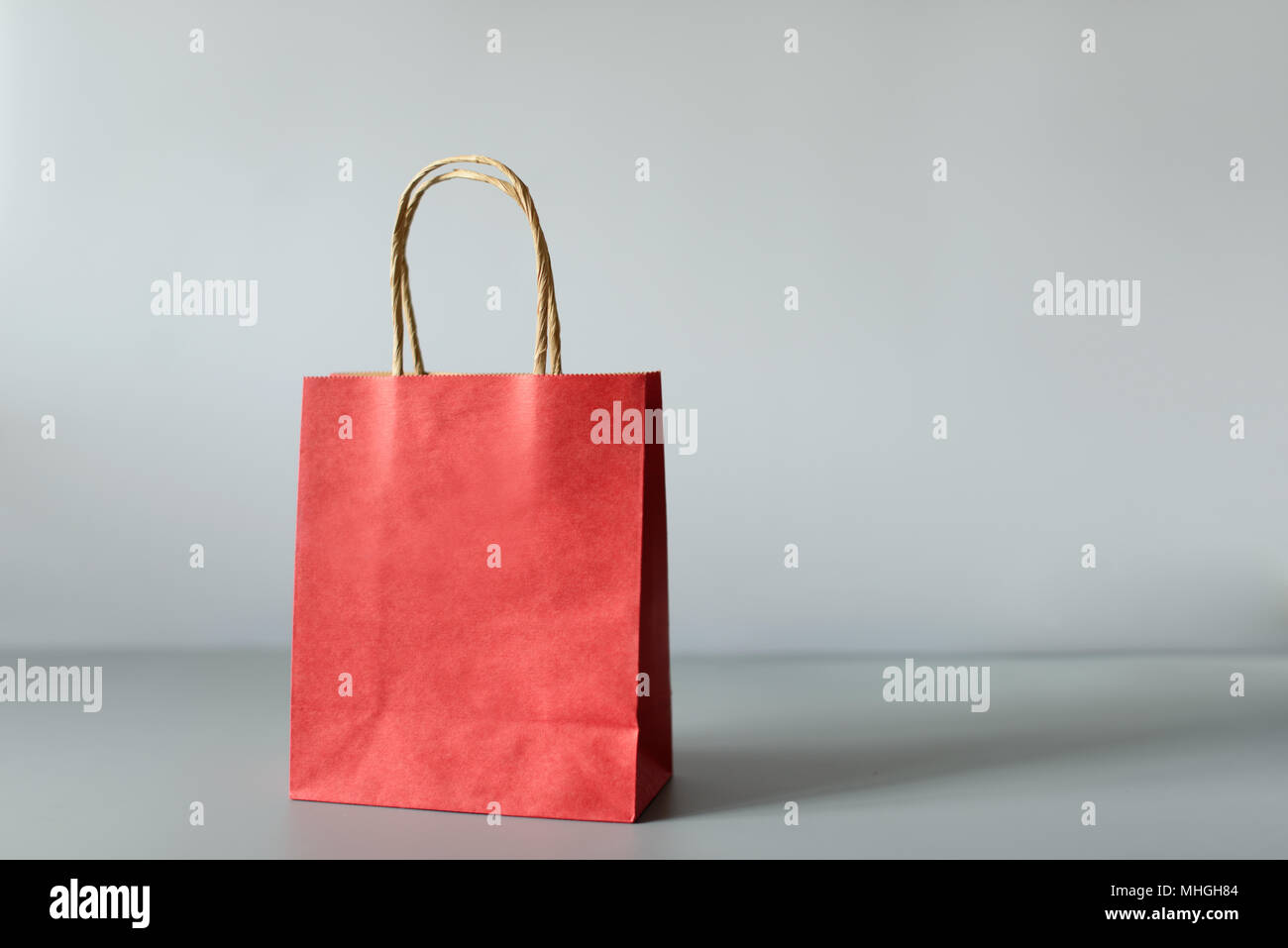 Red shopping bags from recycle paper isolated on white background. Black friday or Christmas sales. Stock Photo