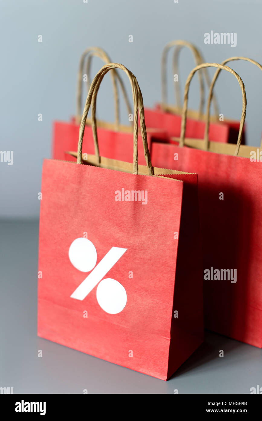 Red shopping bags from recycle paper isolated on white background. Black friday or Christmas sales. Stock Photo