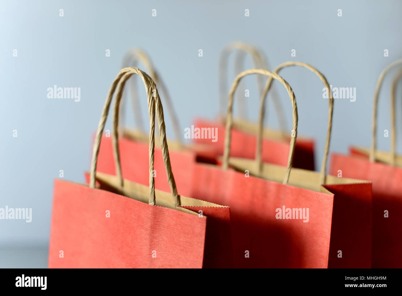 Red shopping bags from recycle paper isolated on white background. Black friday or Christmas sales. Stock Photo