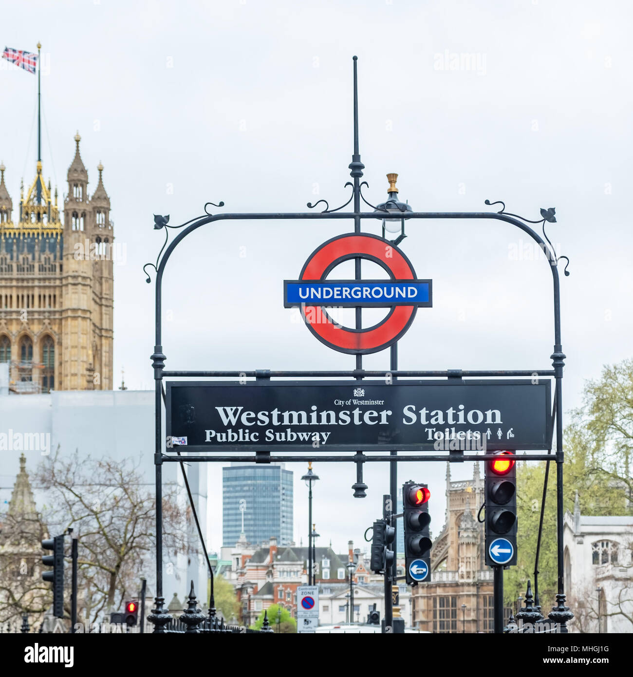 Closeup of Westminster Undergraound station sign with the house of Parliament in the background. Stock Photo
