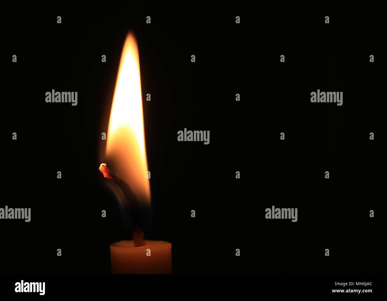 Candle flame burning on black background for design ideas in your work
