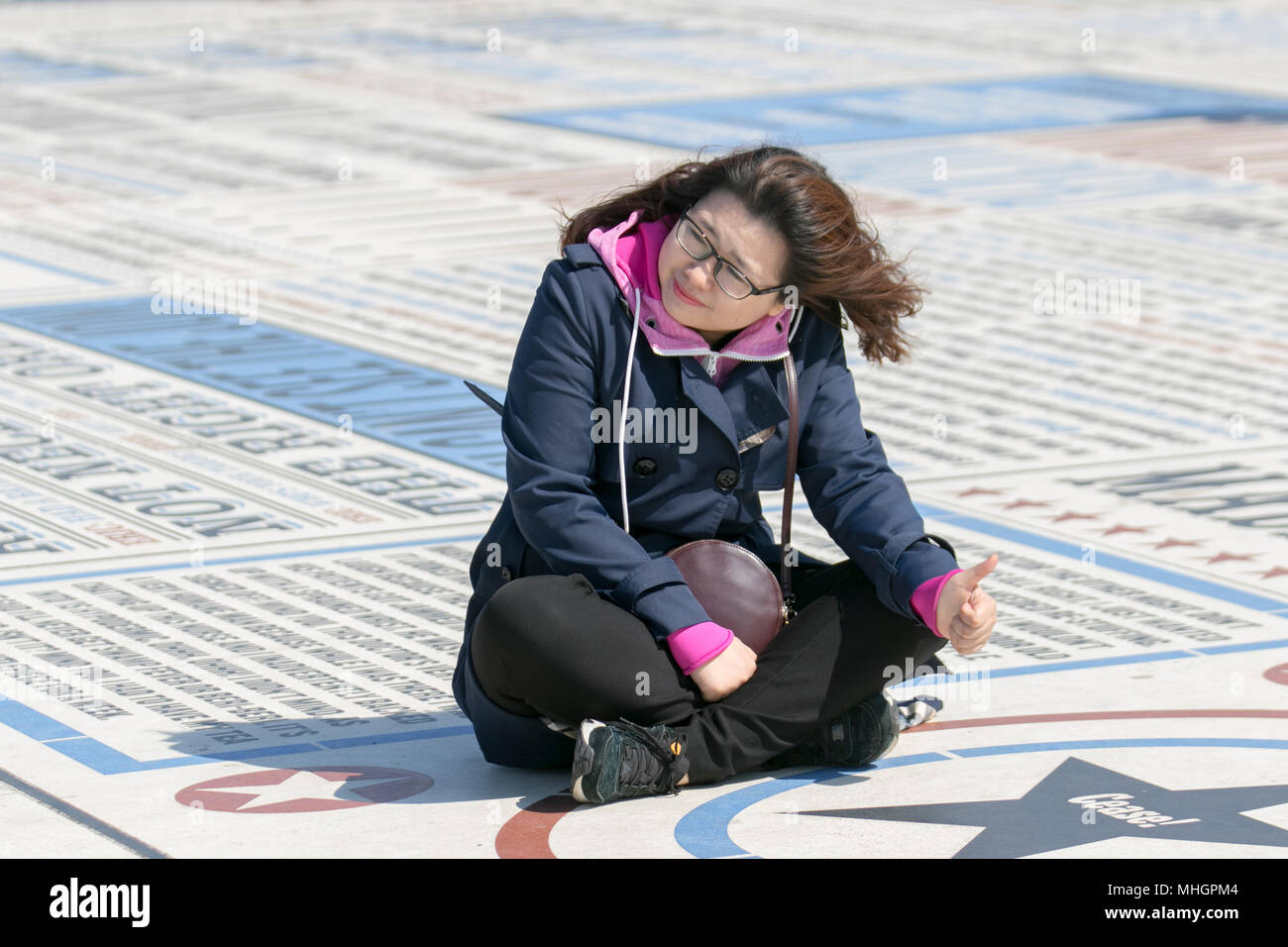 Blackpool Lancashire. 1st May, 2018. UK Weather: Sunny start to the day on the Fylde Coast. Foreign tourists enjoy the attractions on the seafront promenade. The comedy carpet or pavement provides a comic backdrop for photographers intent on taking selfies as they bend, stretch and contort their bodies into unnatural positions to capture the perfect shot. MediaWorldImages/AlamyLiveNews. Stock Photo