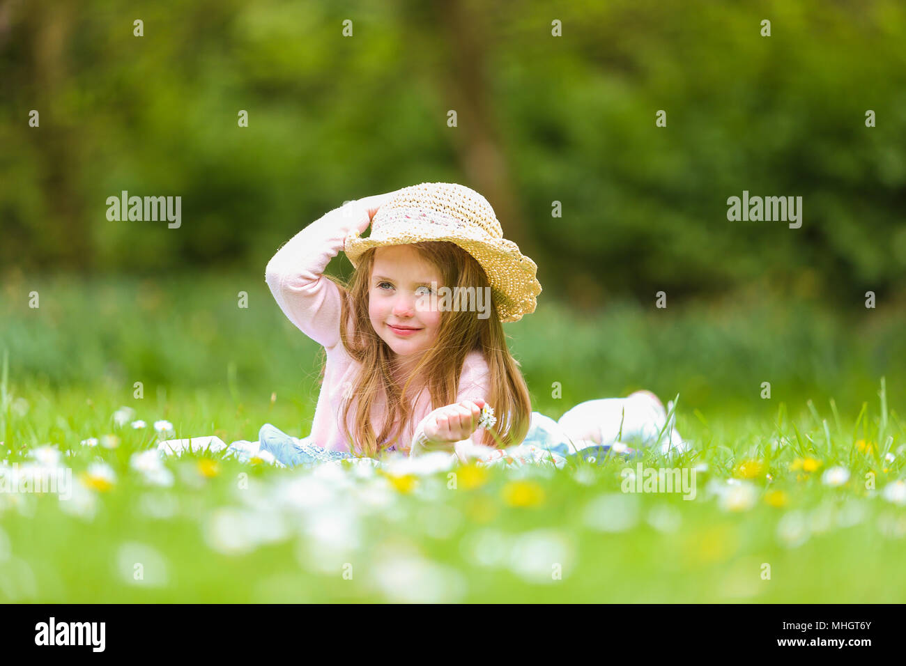 3 pretty blonde girls frolicking on the grass