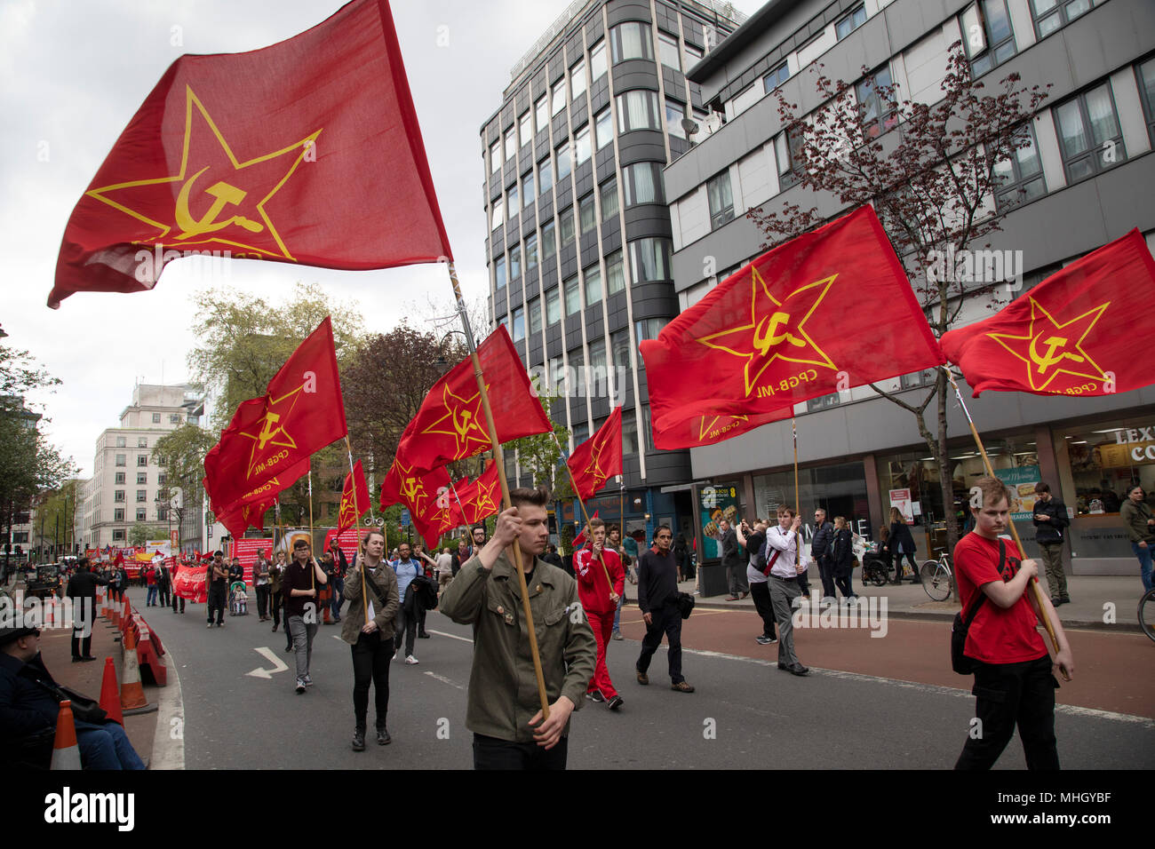 London, UK. 1st May, 2018. Communist Party of Great Britain red flags during May Day celebrations in London, England, United Kingdom. Demonstration by unions and other organisations of workers to mark the annual May Day or Labour Day. Groups from all nationalities from around the World, living in London gathered to march to a rally in central London to mark the global workers day. Credit: Michael Kemp/Alamy Live News Stock Photo