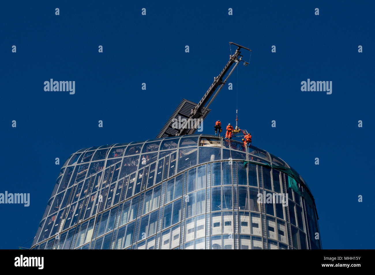 London, UK. 1st May, 2018. Workers take advantage of the clear calm weather in central London to work on the outside of the new apartment block at number 1 Blackfriars in central London. Clear blue skies over the capital city enable construction workers or riggers to work on the outside of a very tall new building at number one Blackfriars. Serious head for heights as workers hang from the outside and top of a new block of apartments in central London. Credit: Steve Hawkins Photography/Alamy Live News Stock Photo