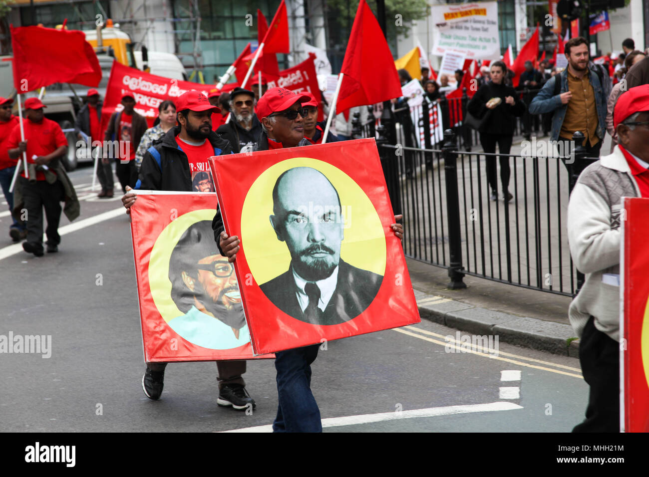 London, UK. 1st May 2018. Mayday Marcher carries Image of Lenin Credit: Alex Cavendish/Alamy Live News Stock Photo