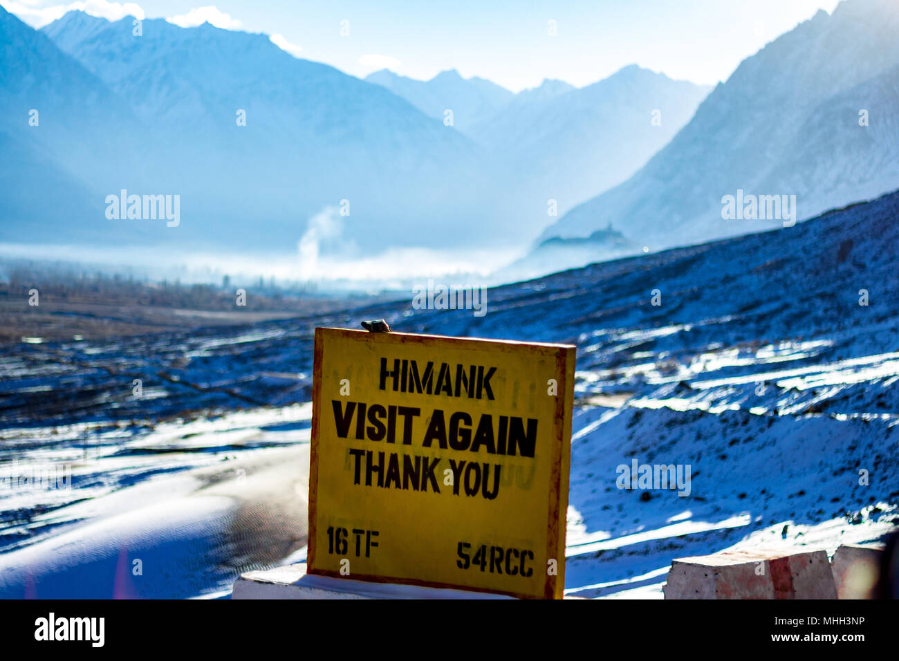 HIMANK - The sign board management committee greets ' VISIT AGAIN THANK YOU '. Stone milestone is located in Ladakh region of Jammu and Kashmir, India. Stock Photo