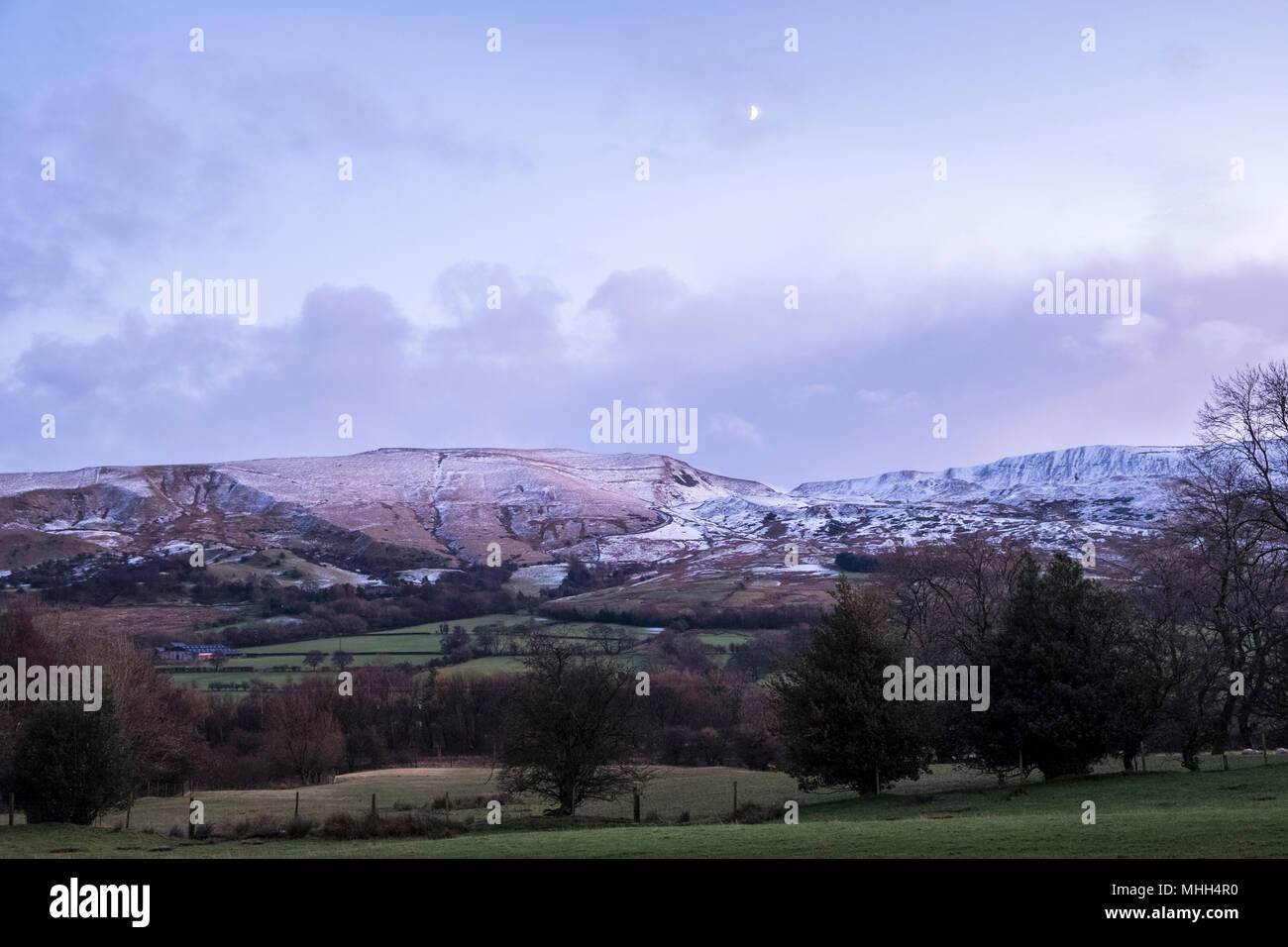 Wintry landscape. Mam Tor and Rushup Edge at dusk in late November with a covering of snow. Vale of Edale, Derbyshire, Peak District, England, UK Stock Photo
