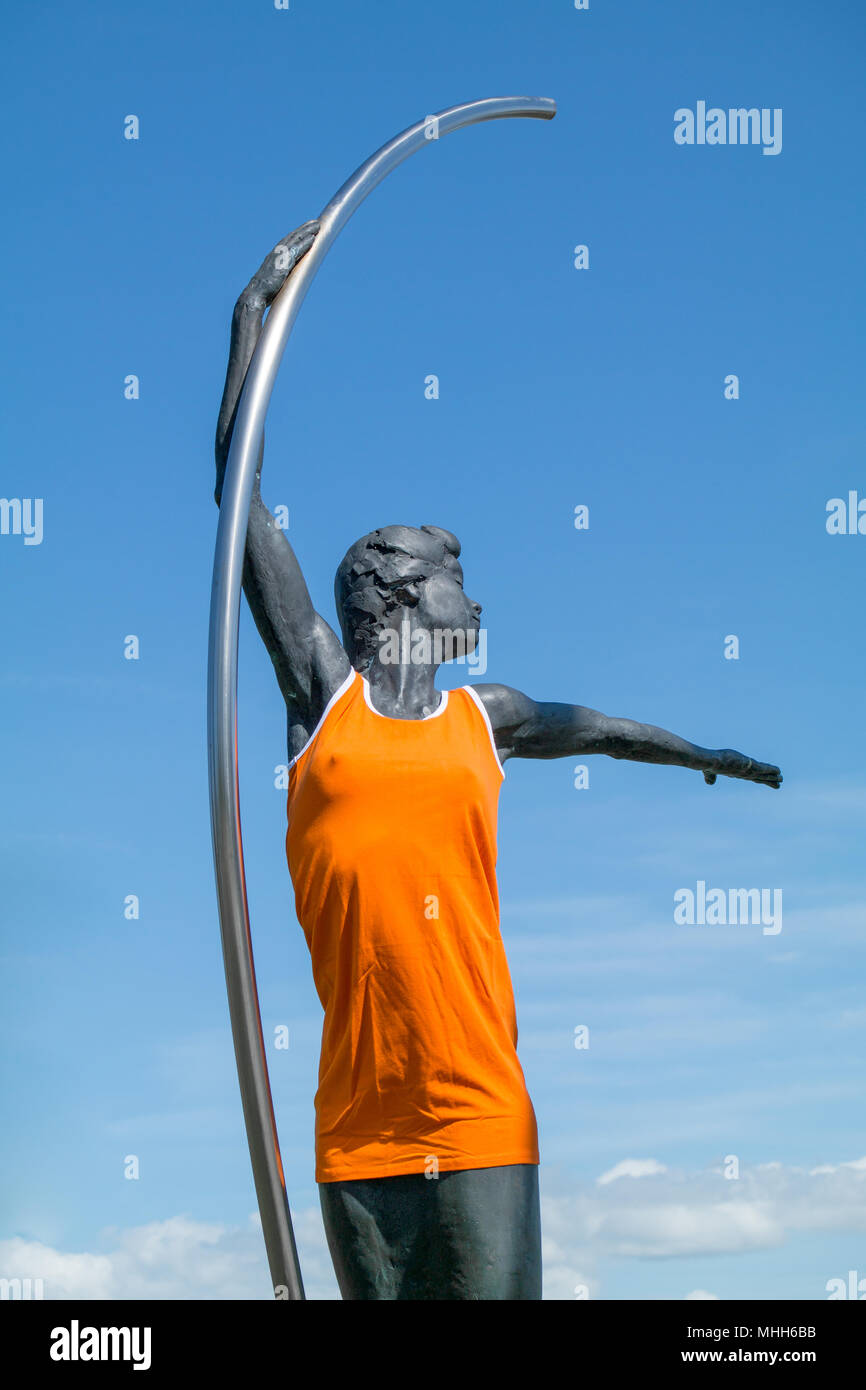 Bronze sculpture of a woman made by Guido Sprenkels dressed up as a Dutch Orange Supporter at the entrance of Parc Allemansgeest in Voorschoten Stock Photo