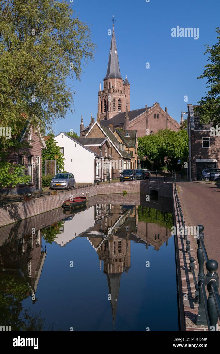 The Protestant Church in Voorschoten mirrored in the water on an early summer morning Stock Photo