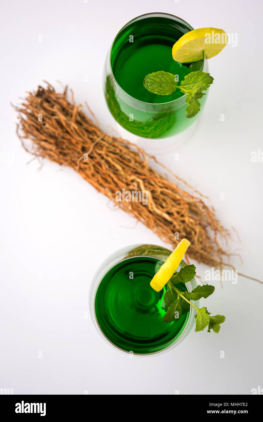Green KHUS Sharbat or Vetiver grass extract or Chrysopogon zizanioides served in tall glass with mint leaf, popular summertime refreshing drink from I Stock Photo