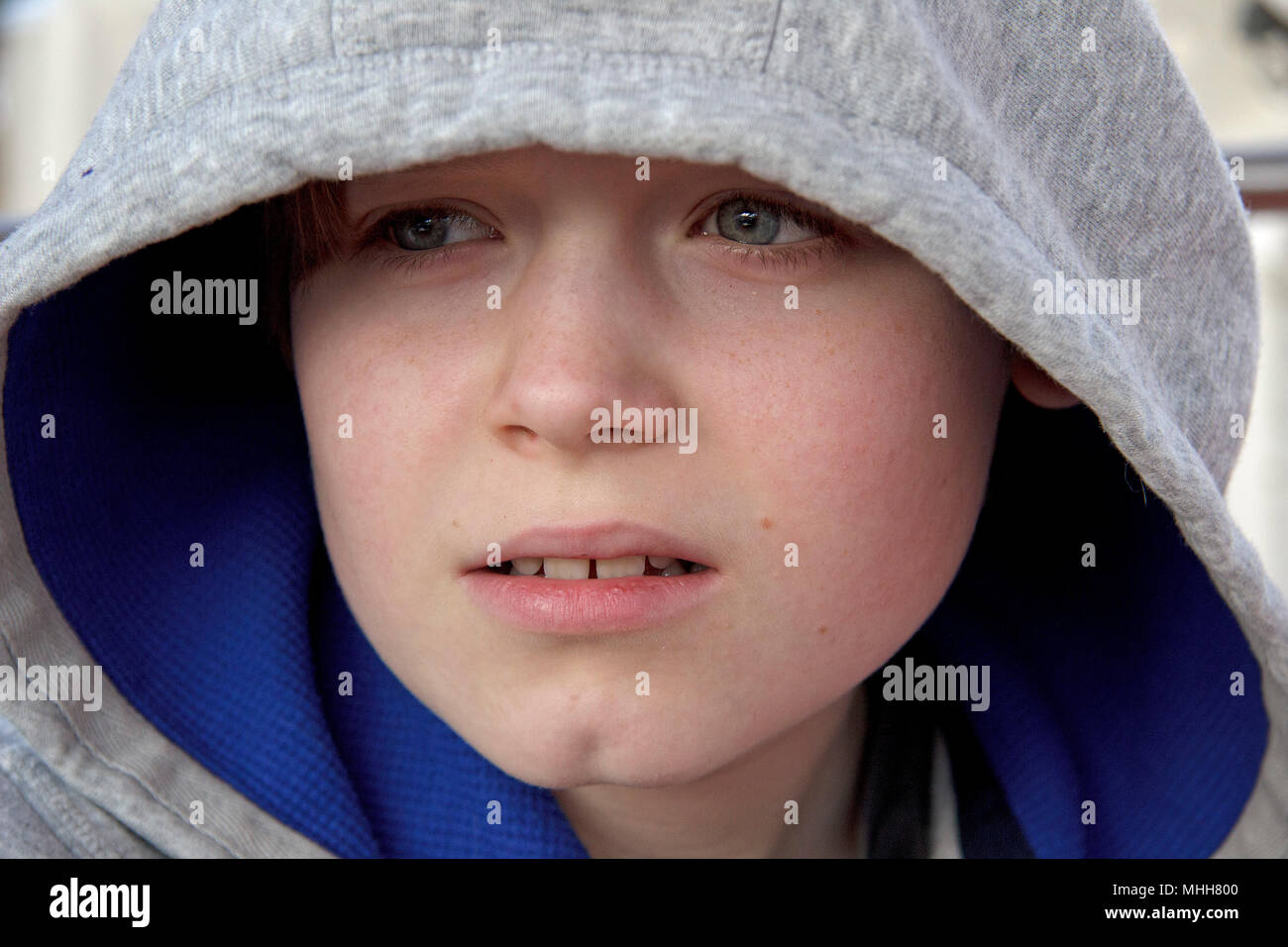 portrait of a boy wearing a hood Stock Photo