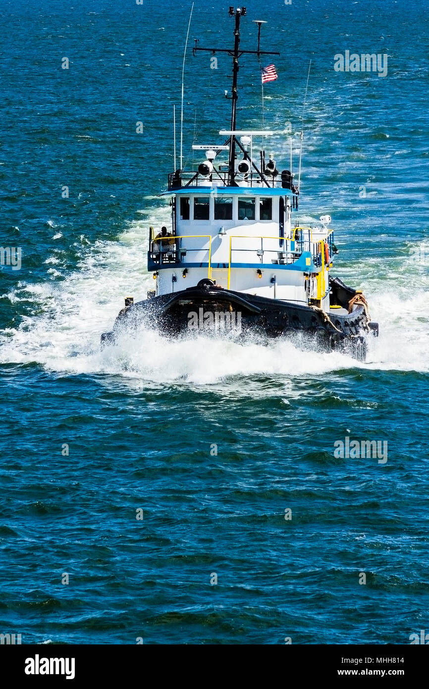 Tug boat out of Tampa Bay Port Authority riding the waves in the Bay. Stock Photo