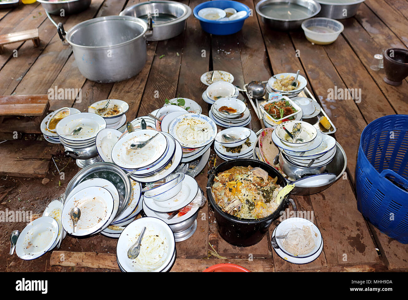 Plate, bowl, spoon. Have not washed. Are stack on wooden board. Food