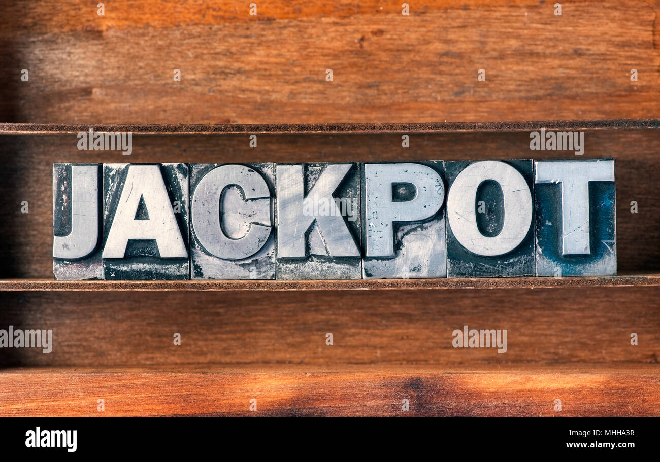 jackpot word made from metallic letterpress type on wooden tray