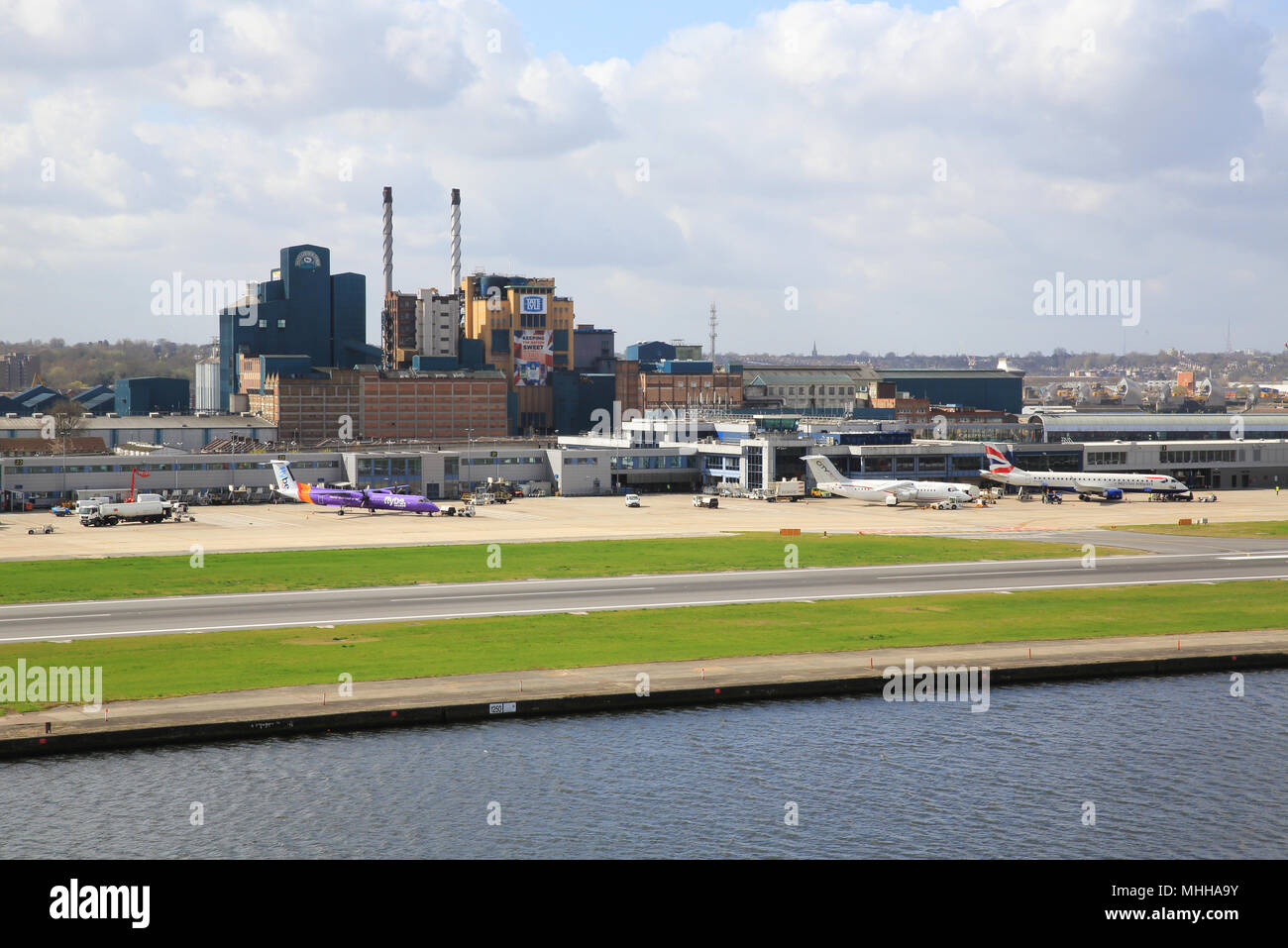 London City International Airport, in Royal Docks with the Tate & Lyle factory behind, in east London, England, UK Stock Photo