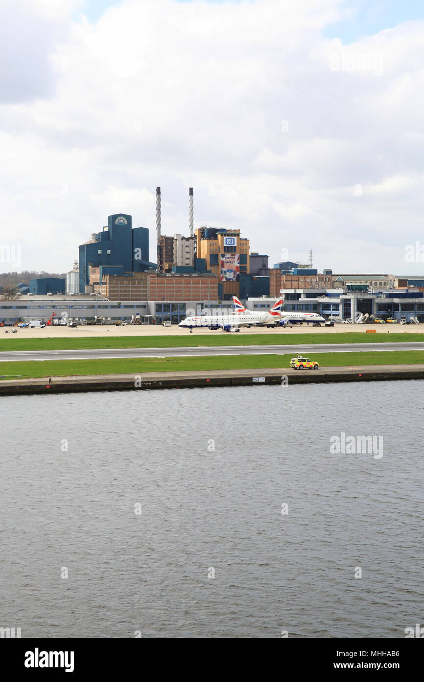 London City International Airport, in Royal Docks with the Tate & Lyle factory behind, in east London, England, UK Stock Photo