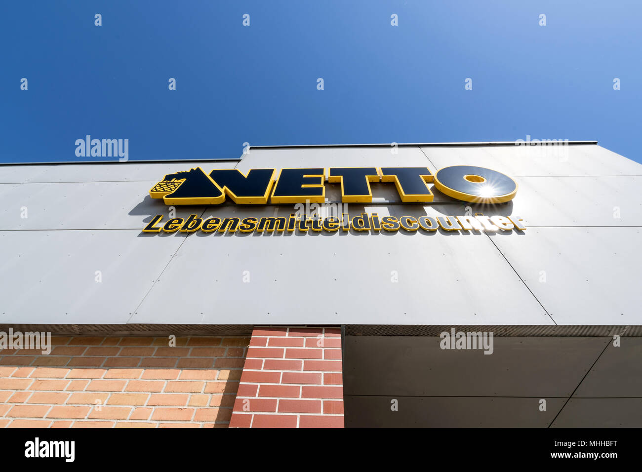 Netto Lebensmitteldiscounter sign at branch. Netto is a Danish discount supermarket operating in Denmark, Germany, Poland and Sweden. Stock Photo