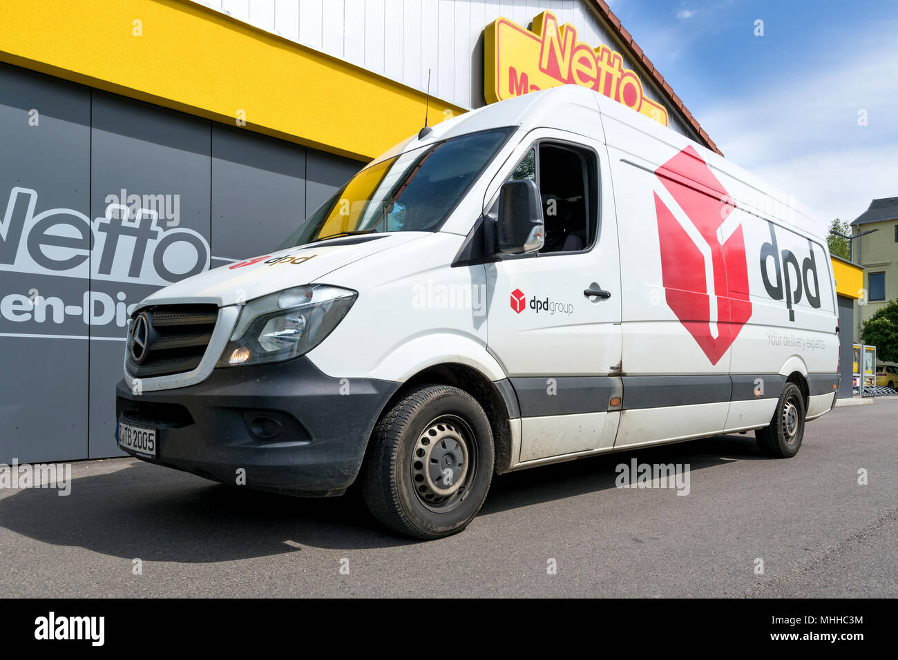 dpd delivery van at Netto discount store. DPDgroup is the international parcel delivery network of French state owned postal service, La Poste. Stock Photo