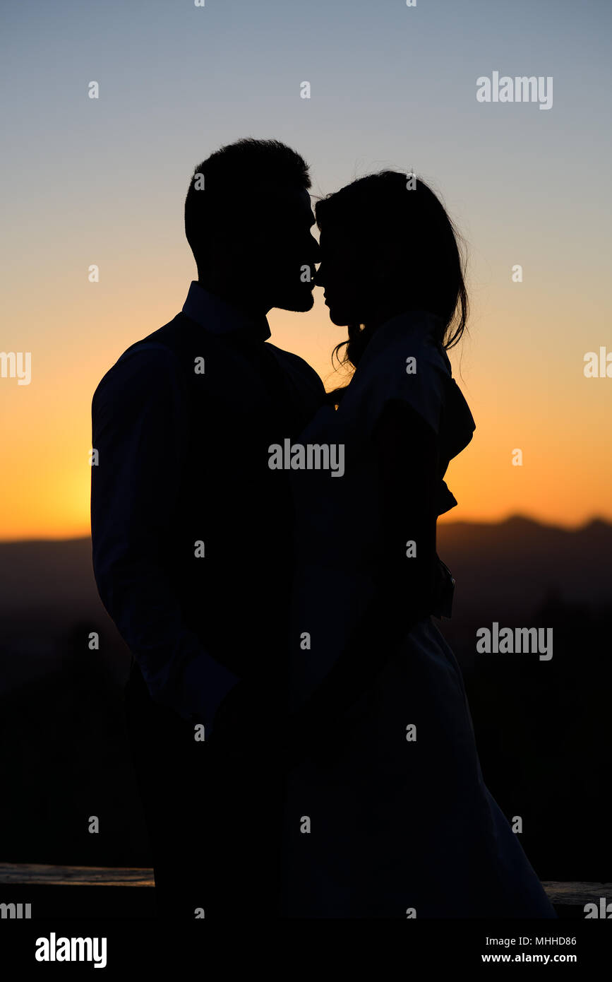 Silhouette of a young bride and groom on Sunset background Stock Photo ...