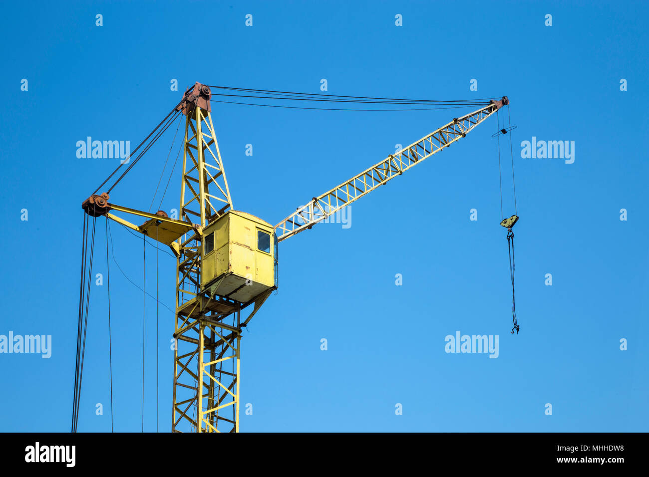 yellow construction elevator crane closeup against the blue sky Stock