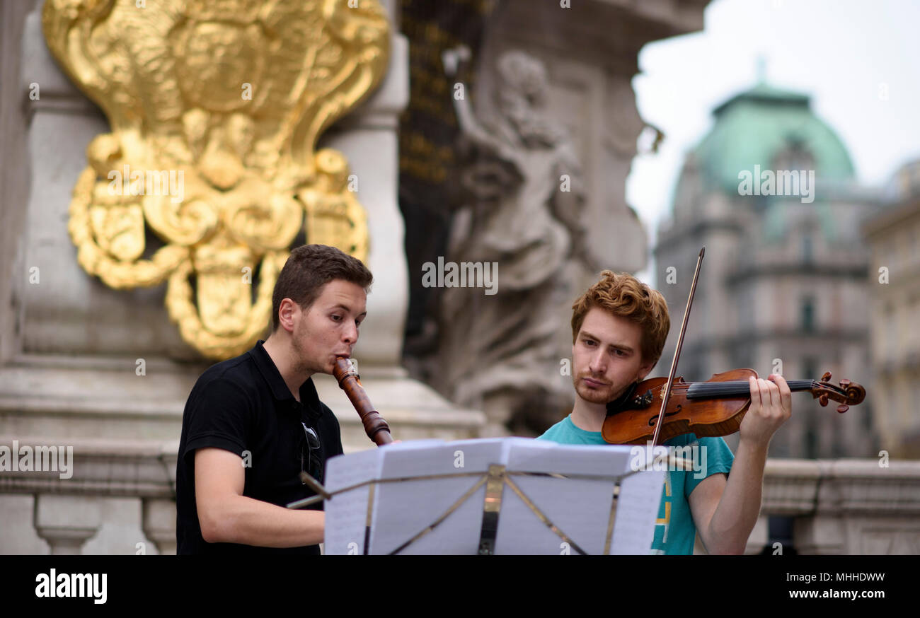 Musicians play at the Trinity column or Plague column on Graben street Vienna, Austria in the summer. Stock Photo
