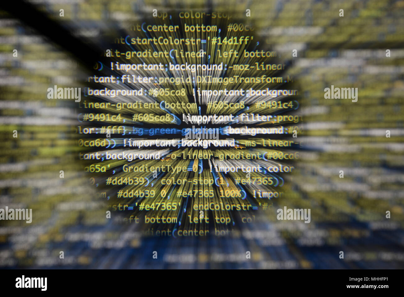 Real css code developing screen. Programing workflow abstract algorithm concept. Lines of css code visible under magnifying lens with moviment effect. Stock Photo