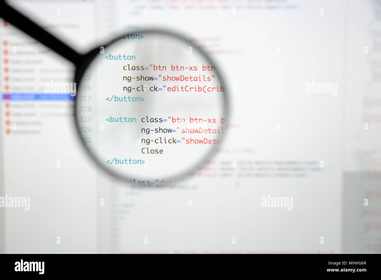 Real Html code developing screen. Programing workflow abstract algorithm concept. Lines of Html code visible under magnifying lens. Stock Photo