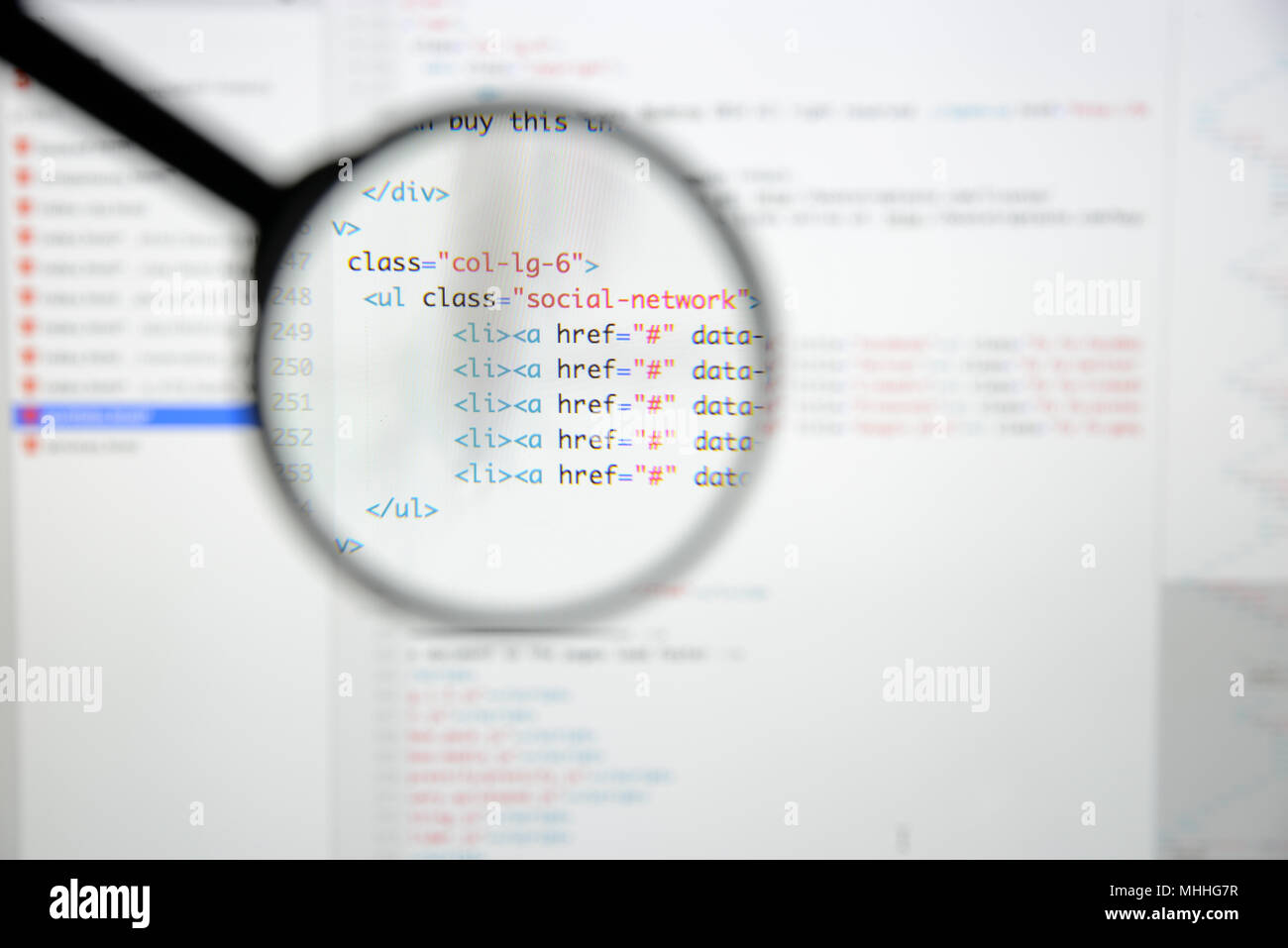 Real Html code developing screen. Programing workflow abstract algorithm concept. Lines of Html code visible under magnifying lens. Stock Photo