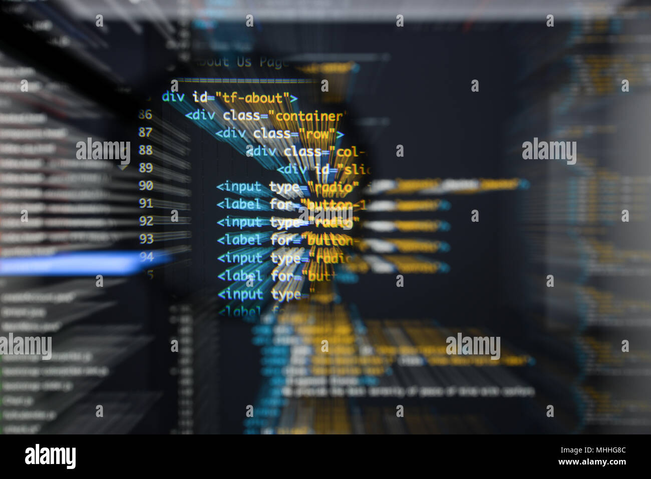 Real Html code developing screen. Programing workflow abstract algorithm concept. Lines of Html code visible under magnifying lens with moviment effec Stock Photo