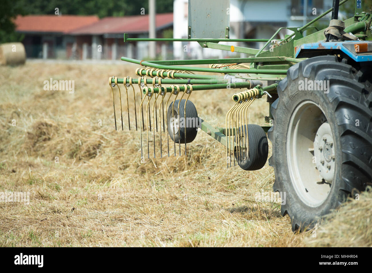 Tractor on green grass field Stock Photo - Alamy