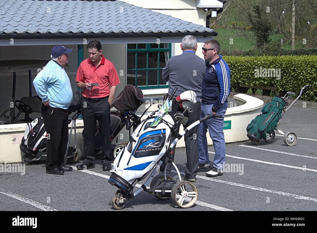 a group of golfers discuss the state of their local golf course before starting their round of the golf competition. Stock Photo