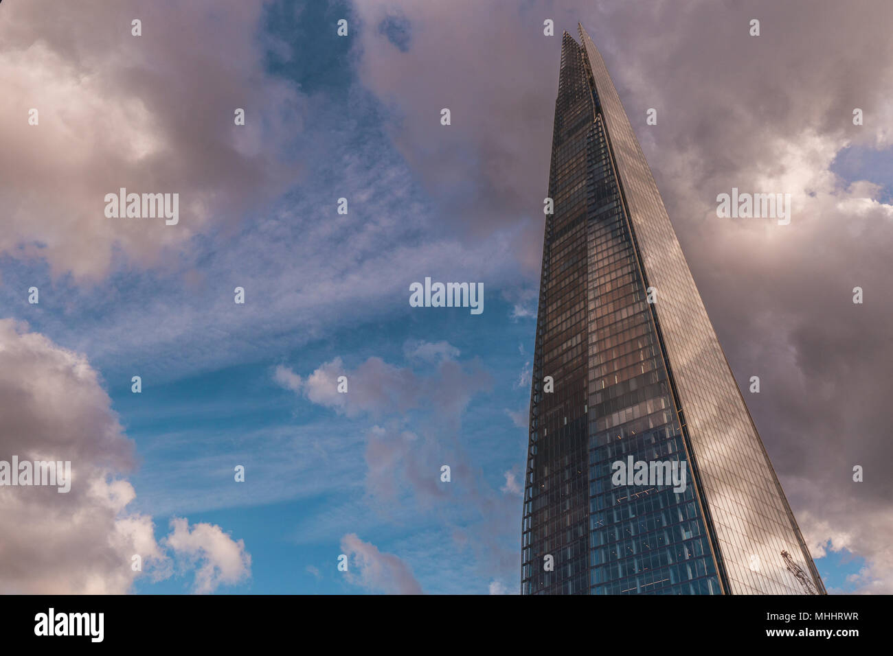 LONDON - APRIL 26, 2018: The Shard skyscraper building in London with blue sky and white clouds Stock Photo