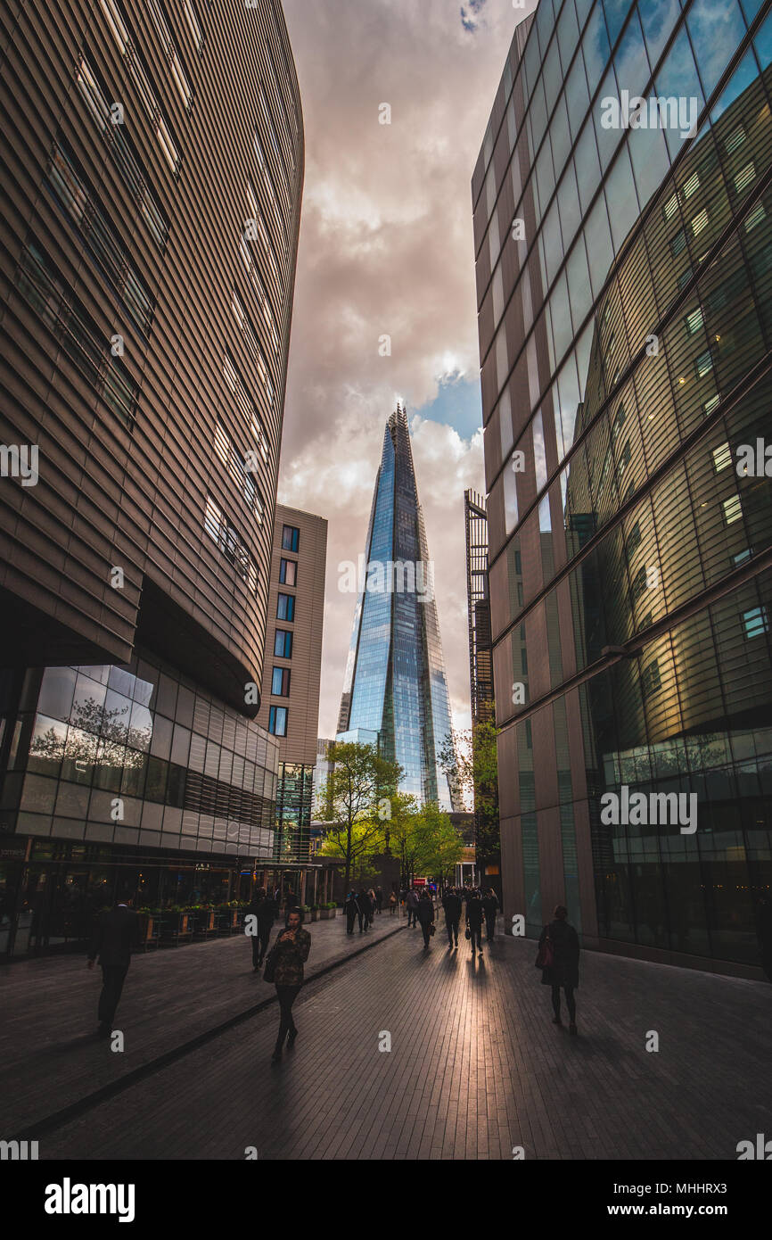 LONDON - APRIL 26, 2018: People walking towards the Shard building in London at sunset Stock Photo